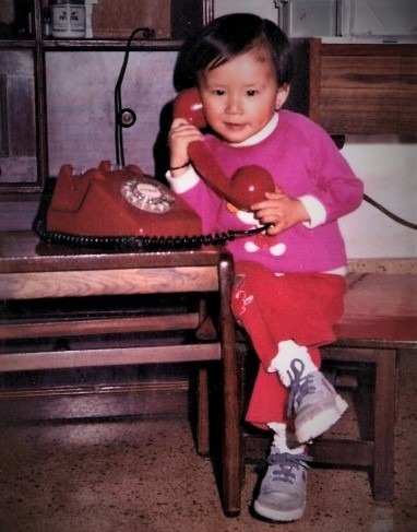 Photo of a young Amanda Chen talking on the phone