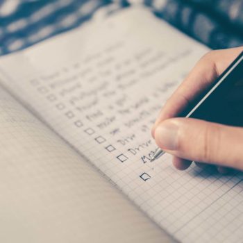 Pen writing on checklist